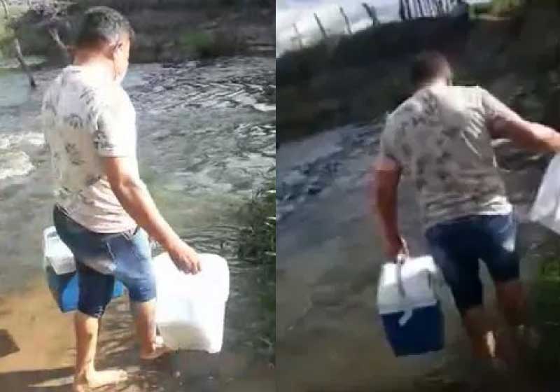 O técnico de enfermagem atravessa rio a pé e vacina idosa no interior da Paraíba. - Foto: reprodução vídeo Jornal da Paraíba